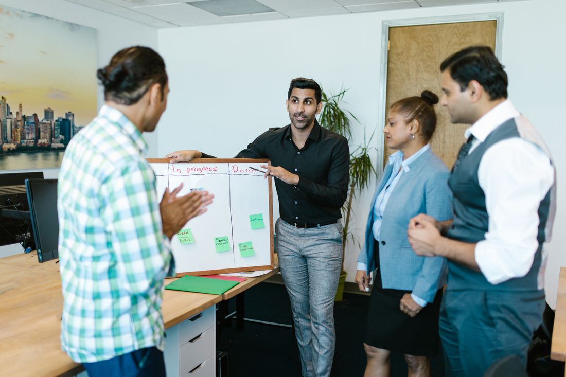 Two professionals shaking hands across a meeting table